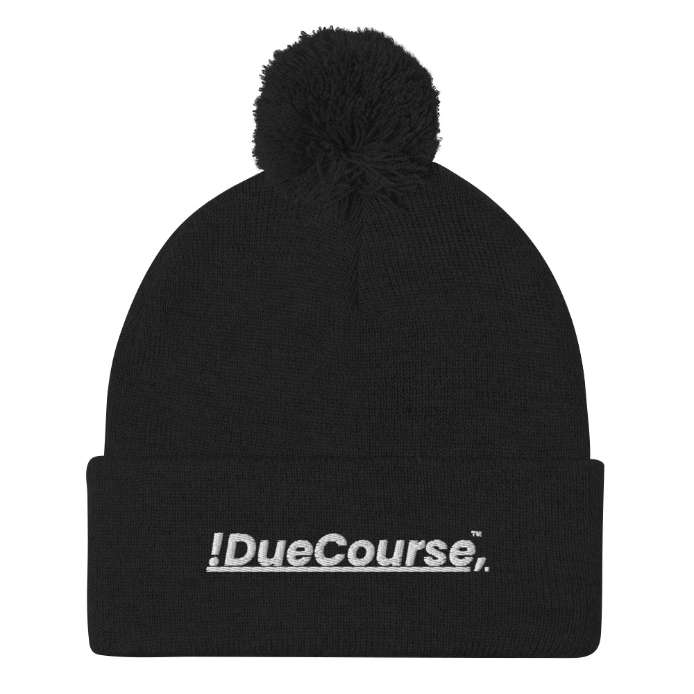 “Black DueCourse beanie with a pom on top, featuring embroidered !DueCourse(TM) logo”